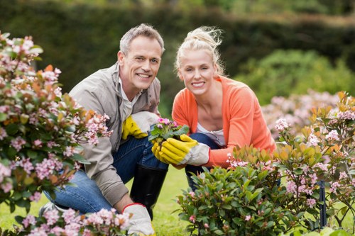 Photo of landscaper demonstrating safe, accessible mowing practices in a front garden